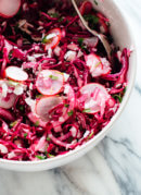 This hot pink slaw is totally irresistible, thanks to—surprise—coconut! If you like coconut, you're going to love this nutrient-dense slaw/side salad. cookieandkate.com