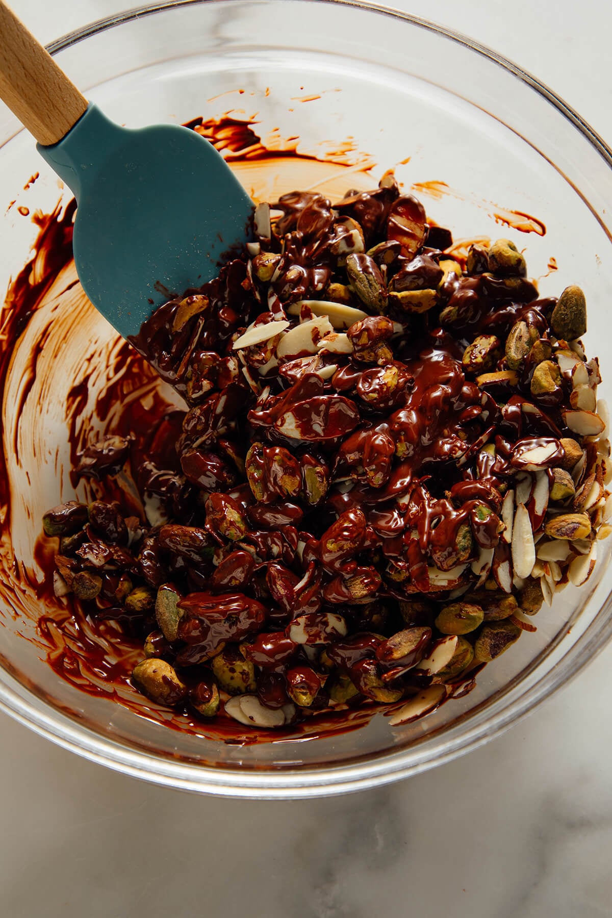 mixing chocolate, almonds and pistachios